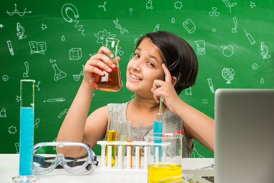 Young girl learning science from science tuition