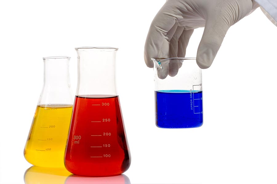 Conical flasks holding different coloured chemicals to be used in experiments