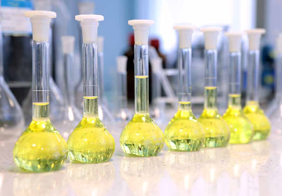 Flasks filled with yellow chemical used in chemistry experiment