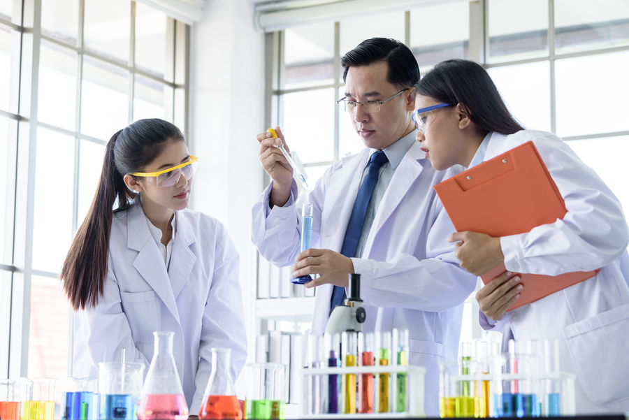 Students attending science tuition class in laboratory