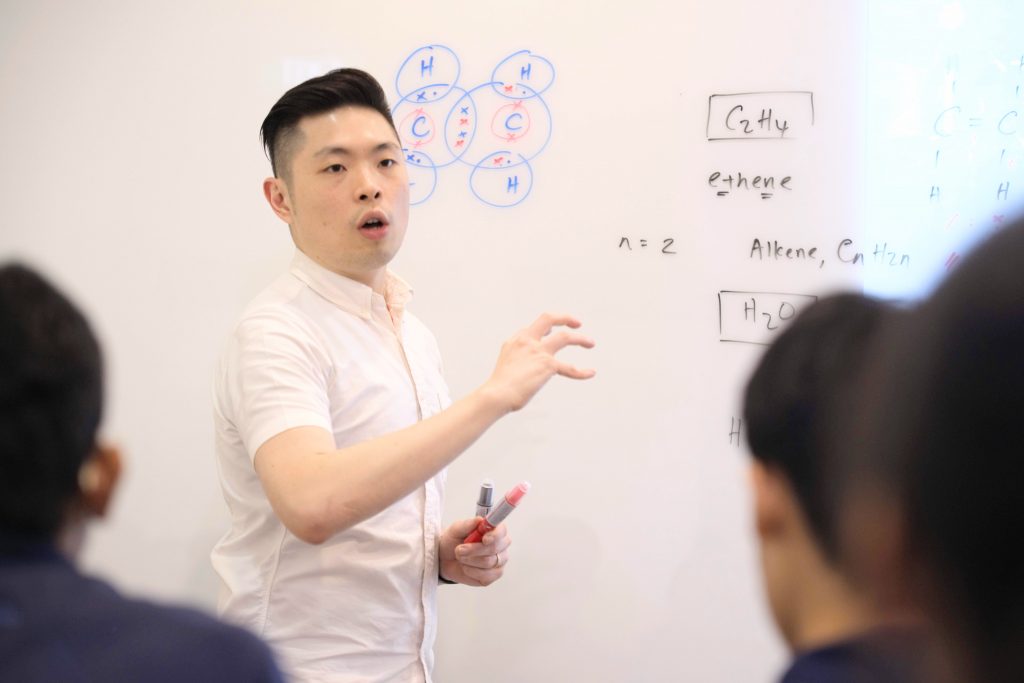 TSA science tutor giving a chemistry lecture to students