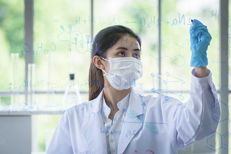 jc chemistry student writing formulas on glass in lab
