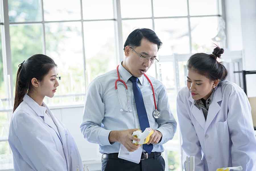 chemistry teacher showing an experiment to students
