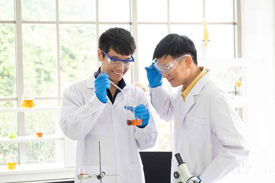 two student chemists conducting a test