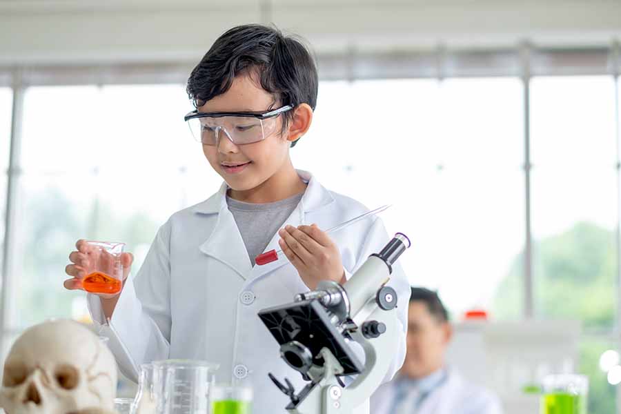 boy having fun performing chemistry experiment boy having fun performing chemistry experiment