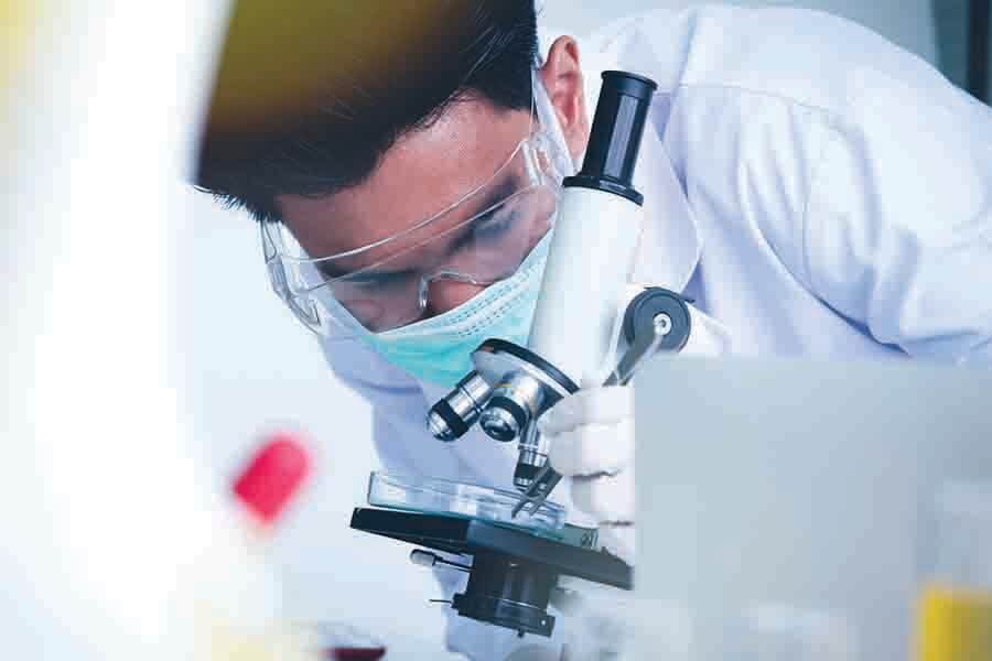 scientist using microscope to observe nano objects scientist using microscope to observe nano objects