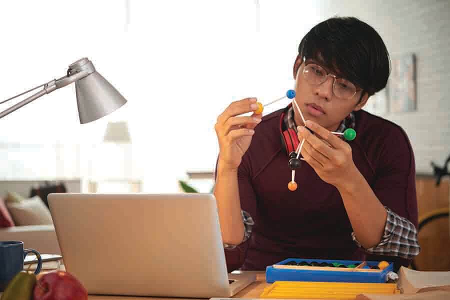 o level physic student examining physics molecular model o level physic student examining physics molecular model