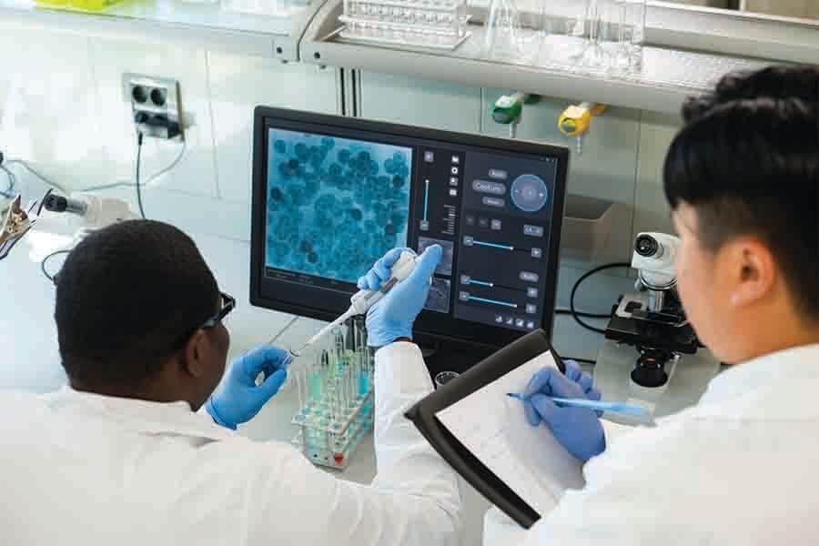 two biochemist doing a research together two biochemist doing a research together