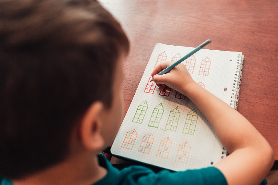 A boy solving math problems
