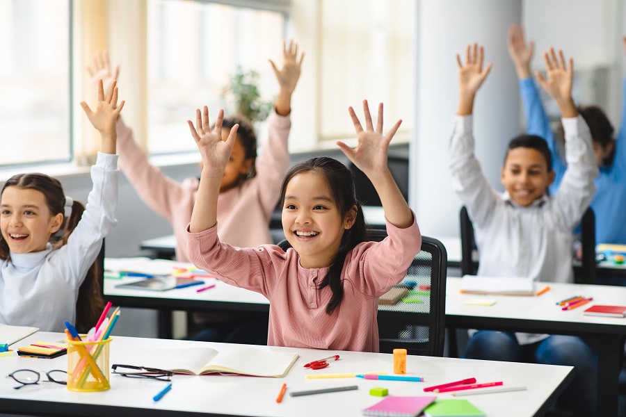 Students happily raising their hands